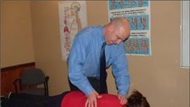 Doctor giving urgent chiropractic treatment to patient in Sandusky