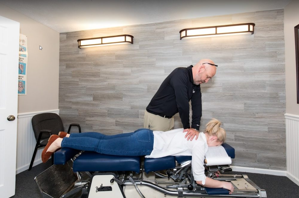 Chiropractic practitioner performing a spinal adjustment on a patient in Sandusky, OH